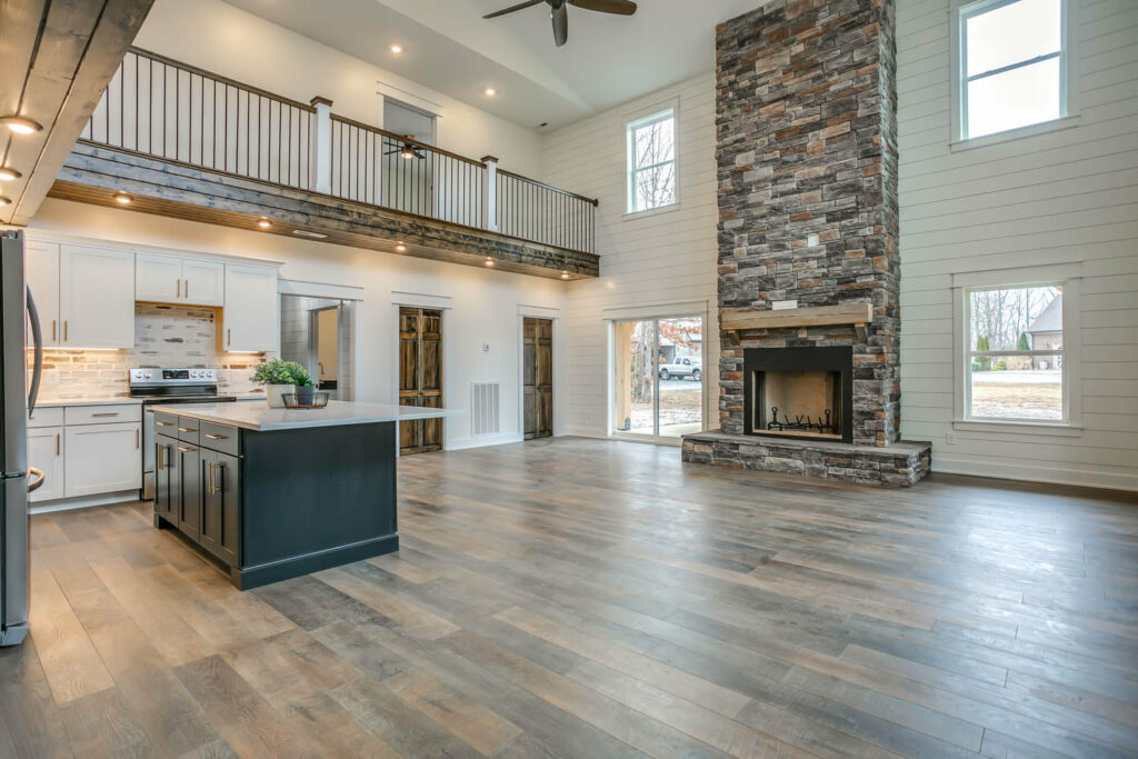 Barndominium in Vermont with fireplace and high ceiling.